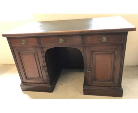 A late 19th century mahogany ladies pedestal desk by S & H Jewell of London. 3 drawers over 2 cupboards with interior shelves