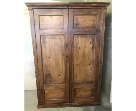 A vintage pine double door wardrobe with internal hanging rail and shelf. Complete with key. Comes apart in 2 sections. Appro