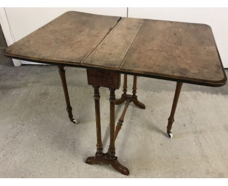 A miniature walnut Victorian Sutherland table with ceramic castors. With turned gate legs. Approx. 51cm wide x 53cm tall (in 