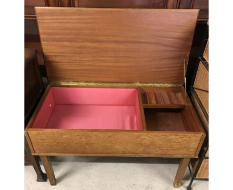 A vintage teak sewing/work box with lift up lid. Interior thread compartments, fully lined. Approx. 78 x 45.5 cm tall.