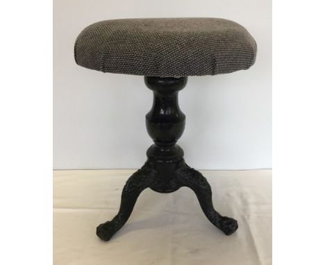A vintage screw top adjustable piano stool with cast iron tripod feet. Has been re-upholstered. 