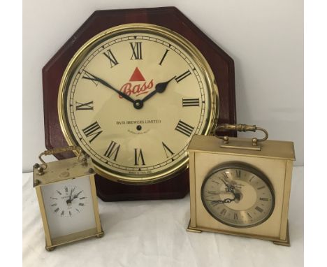 2 vintage German quartz carriage clocks in gold tone cases. Together with a wall hanging Bass Brewers Ltd battery operated cl