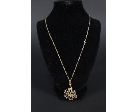 An Art Nouveau style 9ct gold pendant set with blue stones and seed pearls on 9ct gold chain