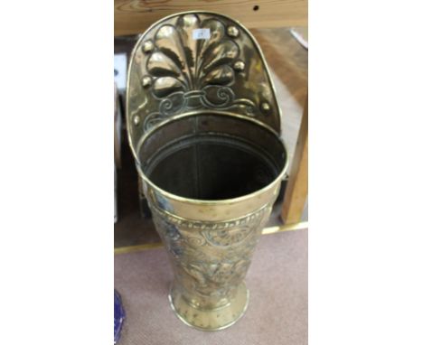 A 19th Century Dutch brass stick stand in the form of a grape hod highly embossed with figures in country scene, 32" high