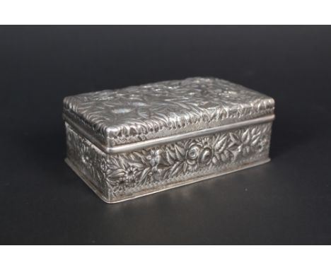 An American sterling silver trinket box with extensive floral embossed details, velvet lined interior, marked Sterling, maker