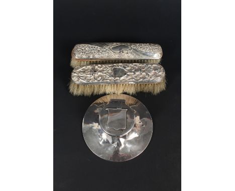 A silver Capstan inkwell (as found) plus two silver backed clothes brushes (as found)