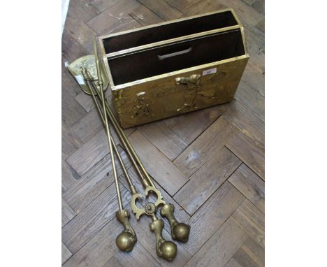 A set of three brass fire irons, fireguard and magazine rack