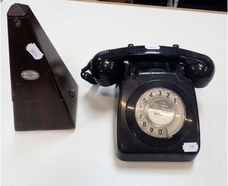 A VINTAGE BLACK DIAL TELEPHONE and a metronome (2)