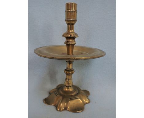 A PETAL FOOT BRASS CANDLESTICK 18th century, with broad drip pan