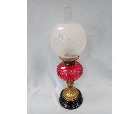 A VICTORIAN OIL LAMP WITH CRANBERRY GLASS FONT (burner only converted to electricity)