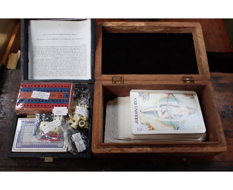 A TRAVELLING GAMES COMPENDIUM including palying cards, chess and a cribbage board and a set of Tarot cards in a wooden box