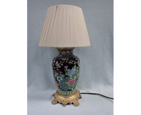 A CHINESE PORCELAIN TABLE LAMP with enamel decoration, on an ormolu base, with pleated shade 47 cm high overall