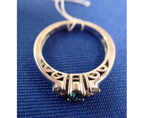 A THREE STONE BLUE AND WHITE DIAMOND RING the central round, brilliant-cut treated blue diamond flanked on either side by a s