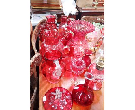 A COLLECTION OF CRANBERRY GLASS including jugs and an oil lamp