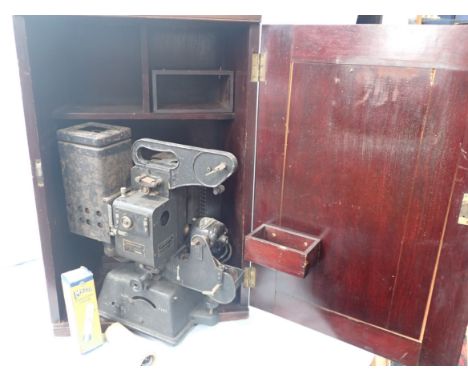A 'KODASCOPE' CINE PROJECTOR with mahogany case,  65 cm high (generally scruffy condition)
