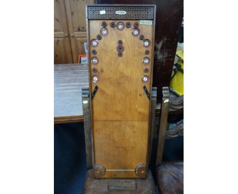 A VINTAGE 'NYNER' 'KUM-BAK' GAME circa 1930s, with sliding steel discs