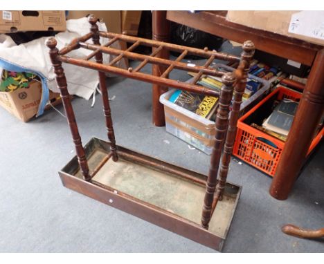 A LATE VICTORIAN STAINED BEECH STICK STAND with an associated copper drip pan