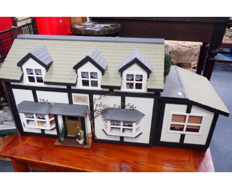 A LARGE VINTAGE DOLL'S HOUSE, 'MAYFLY COTTAGE' in a Tudor style, fully furnished and restored, 101cm wide