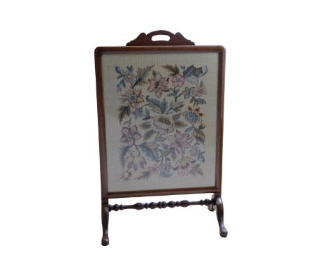 AN EDWARDIAN NEEDLEWORK FIRESCREEN in a mahogany frame, 86cm high