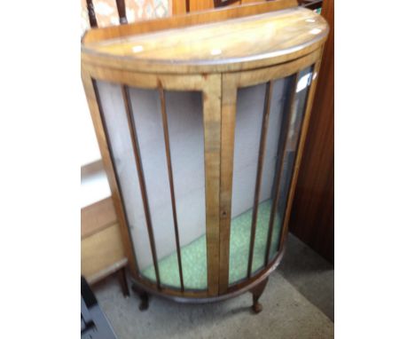 A GLAZED BOW FRONT DISPLAY CABINET