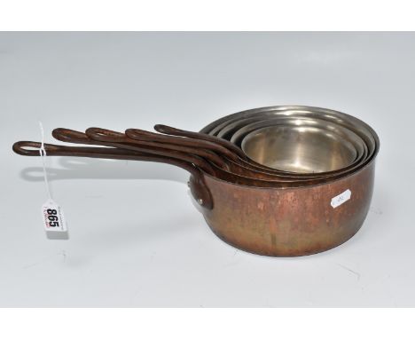 A GROUP OF FIVE GRADUATING FRENCH COPPER COATED SAUCEPANS all with cast-iron handles, unmarked, largest diameter 21.5cm, smal