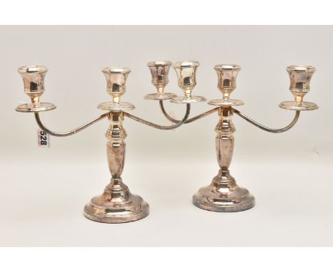 A PAIR OF ELIZABETH II SILVER THREE BRANCH CANDLESTICKS, tapered stems on round weighted bases, hallmarked 'J P' Birmingham 1