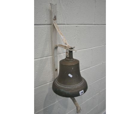 A GEORGE VI BRASS BELL, engraved G R VI, with a hanging striker and rope handle, attached to a white painted bracket, bracket