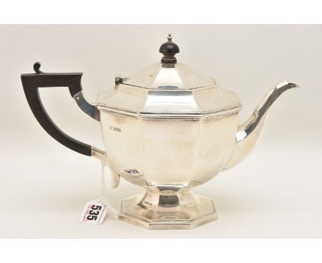 A GEORGE V SILVER TEAPOT, polished hexagonal form, with raised hexagonal base, hinged cover fitted with an ebonised finial an