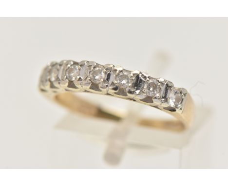 A 9CT GOLD DIAMOND HALF ETERNITY RING, set with a row of seven small round brilliant cut diamonds, each in a claw setting, to