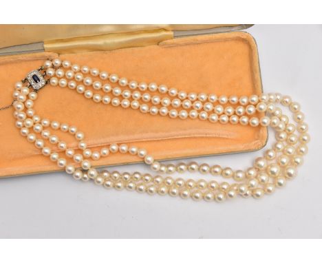 A THREE STRAND CULTURED PEARL NECKLACE, three strands of individually knotted, graduated cream pearls with a pink hue, larges