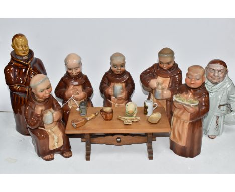 A SET OF WEST GERMAN CORTENDORF DECANTERS MODELLED AS MONKS, the five monks holding tankards of mead or a plate of food, seat
