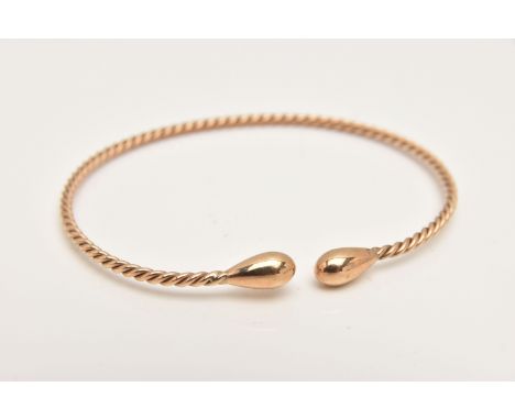 A 9CT GOLD TWIST TORQUE BANGLE, hallmarked 9ct London, approximate internal diameter 65mm, polished terminals, approximate gr