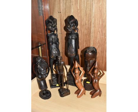 A GROUP OF MOSTLY MID TWENTIETH CENTURY WEST AFRICAN WOODEN SCULPTURES comprising a pair of two kneeling females height 26cm 