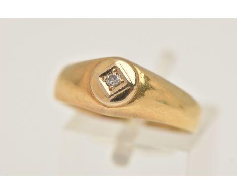 A YELLOW METAL DIAMOND SINGLE STONE RING, set with a small single cut diamond, to a polished band, stamped 750, ring size O, 