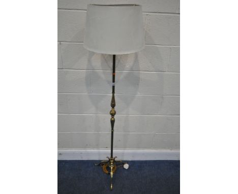 A BRASS STANDARD LAMP, with foliate details, raised on three scrolled legs, height to fitting 138cm, condition report: overal