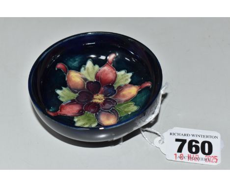 A MOORCROFT POTTERY COLUMBINE FOOTED BOWL, tube-lined with a purple and yellow columbine flower on a graduated blue to green 