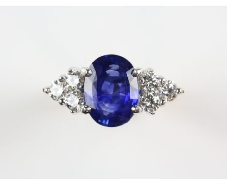 Modern sapphire and diamond ring, oval cut sapphire weighing an estimated 2.85 carats, with a trefoil of round brilliant cut 