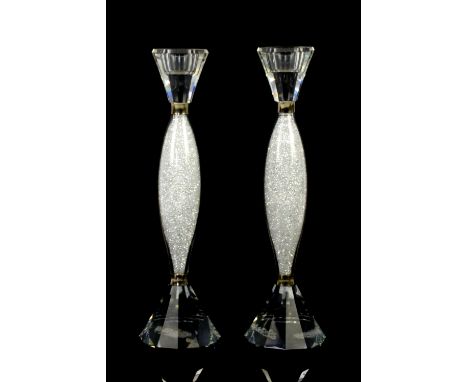 Two Swarovski crystalline candleholders no. 905352, the stems with crystal chatons, having faceted sconces and faceted taperi