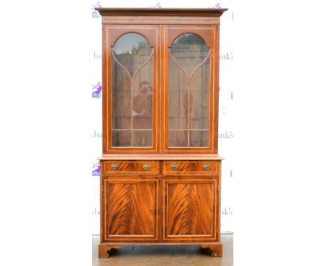 20th century mahogany bookcase cabinet with two astragal glazed doors above two short drawers above a cupboard on bracket fee