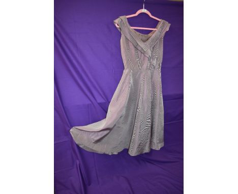 A 1950s checked dress having wide frilled neckline gathering into waistband, fairly full skirt, side metal zip, lined bodice,