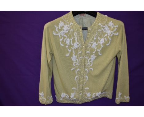 A 1950s mint green Jaeger cashmere cardigan with extensive beadwork, medium size approx.
Very good, beadwork in good order, d