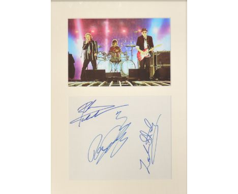 The Who; three signatures, Pete Townsend, Roger Daltrey, Zak Starksy, mounted, framed and glazed with photo above, 38cm by 25