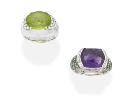 TWO GEM-SET AND DIAMOND DRESS RINGS1st: The oval-cut peridot, between shoulders pavé-set with brilliant-cut diamonds, 2nd: Th