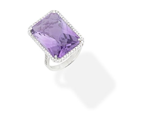 AMETHYST AND DIAMOND RINGThe fancy-cut amethyst within a surround of brilliant-cut diamonds, ring size approx. J For further 