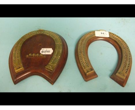 A brass cribbage board, in the form of a horseshoe, mounted on a wooden plinth, 15 cm wide, and another (2)