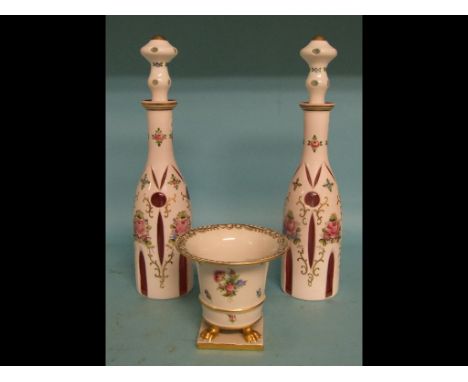 A Herend porcelain bowl, with painted floral and gilt decoration, 13 cm high, and a pair of cranberry cased glass decanters a