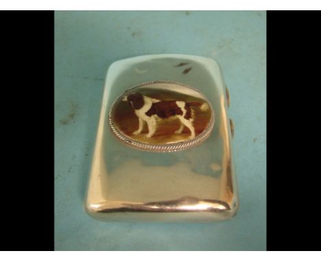 A silver cigarette case, later applied a plaque decorated a dog