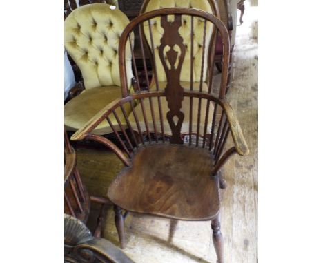 A Victorian beech and elm stick back kitchen armchair
