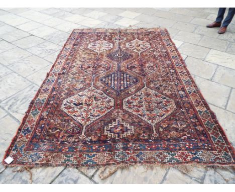 A carpet, with geometric designs within a multi border, 193 x 295 cm