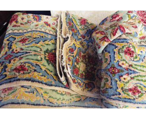 A large Chinese carpet, floral decoration, on a green ground, 510 x 232 cm